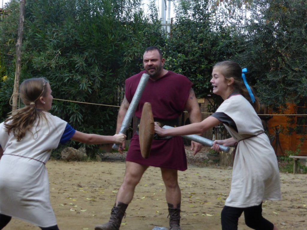 Two sisters fight with gladiator "weapons"