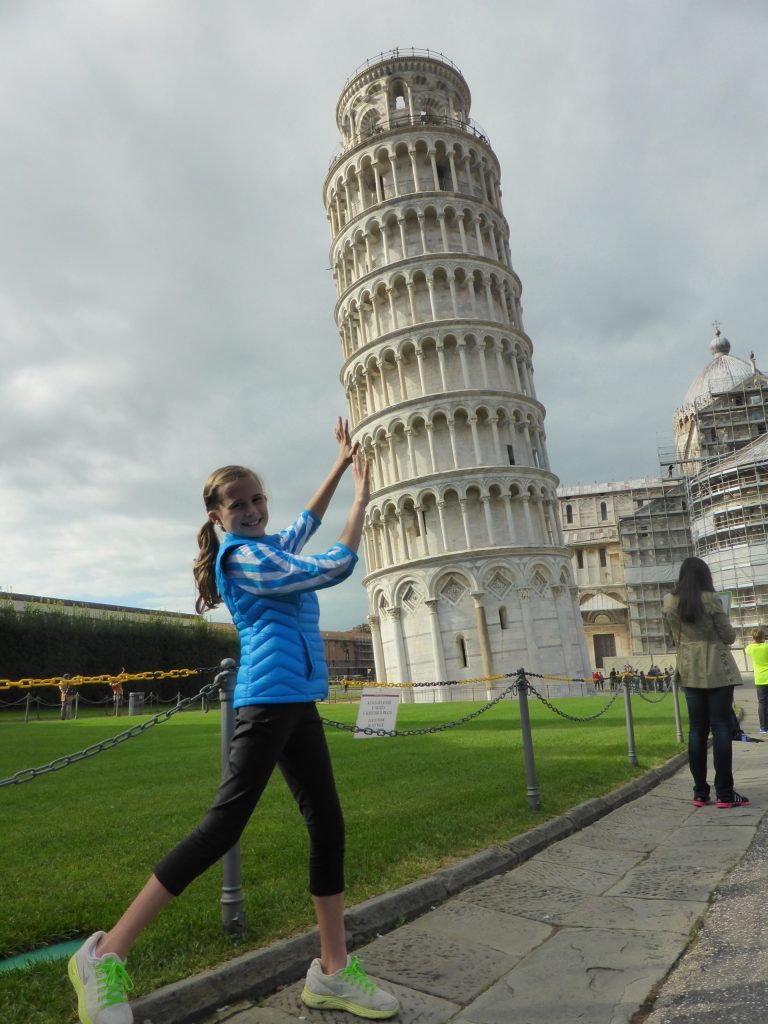 Girl posing like she's supporting the Leaning Tower