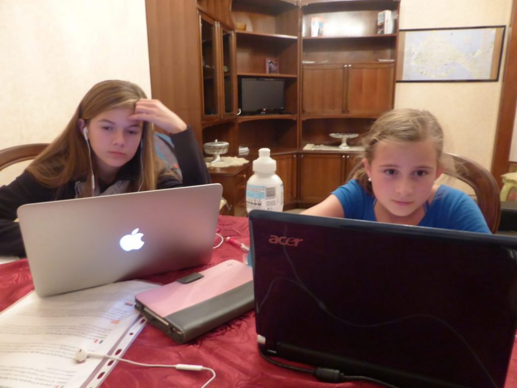 Image of two girls working on Acer and MacBook Air