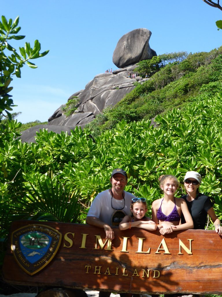 Family stands behind Similan Thailand sign