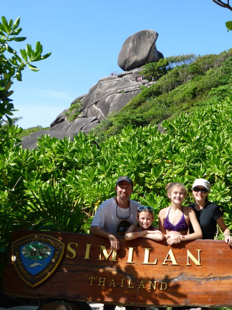 Family stands behind Similan Thailand sign