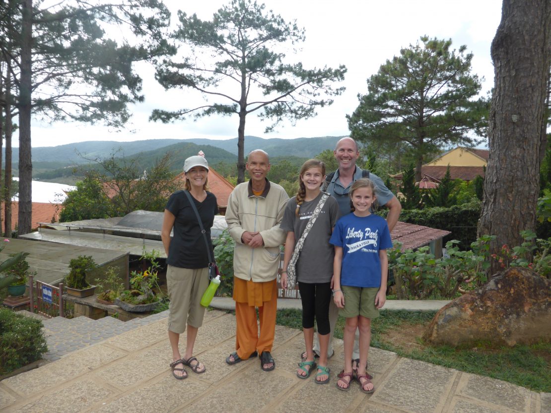 Family with Buddhist monk at Truc Lam