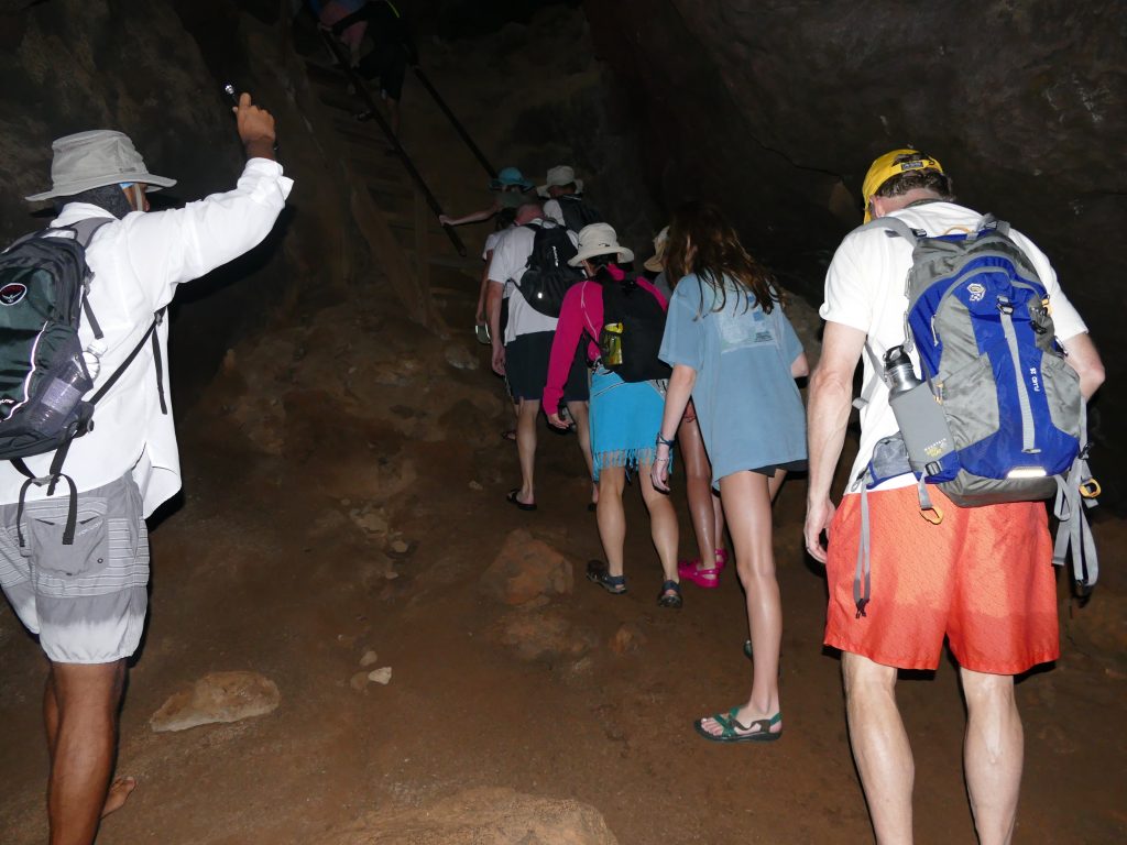 walking through a dark lava tunnel on Floreana Island