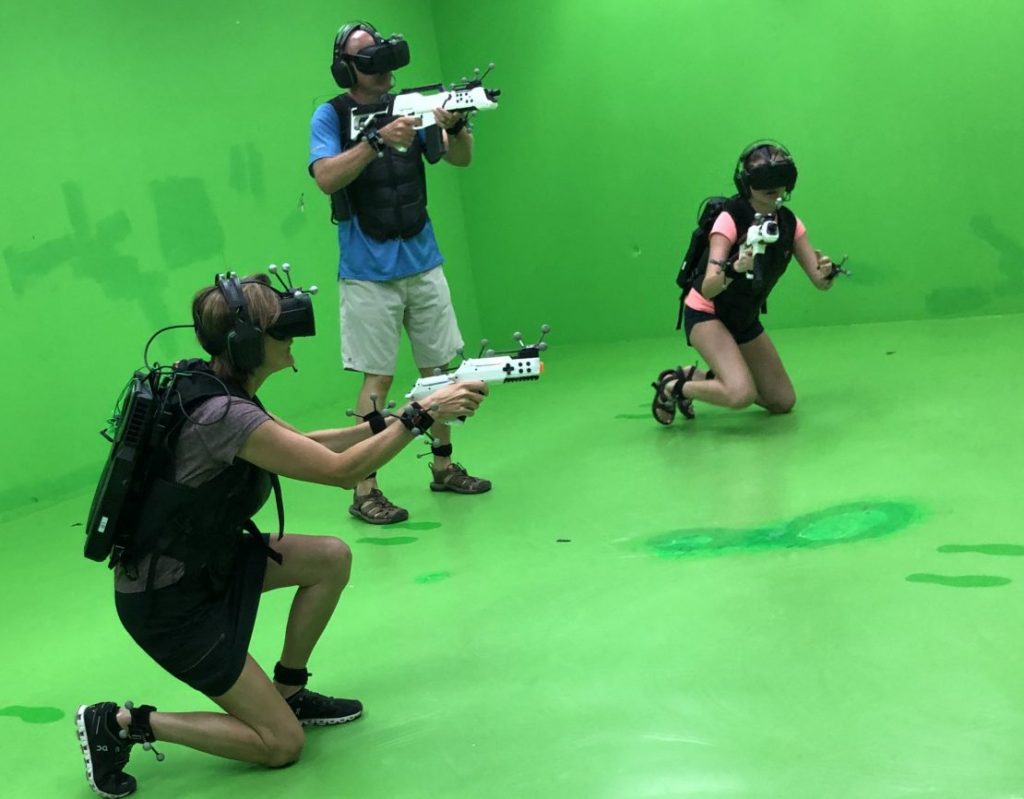Family killing zombies at Sandbox Virtual Reality in Singapore. Top things to do in Singapore with kids and teens.