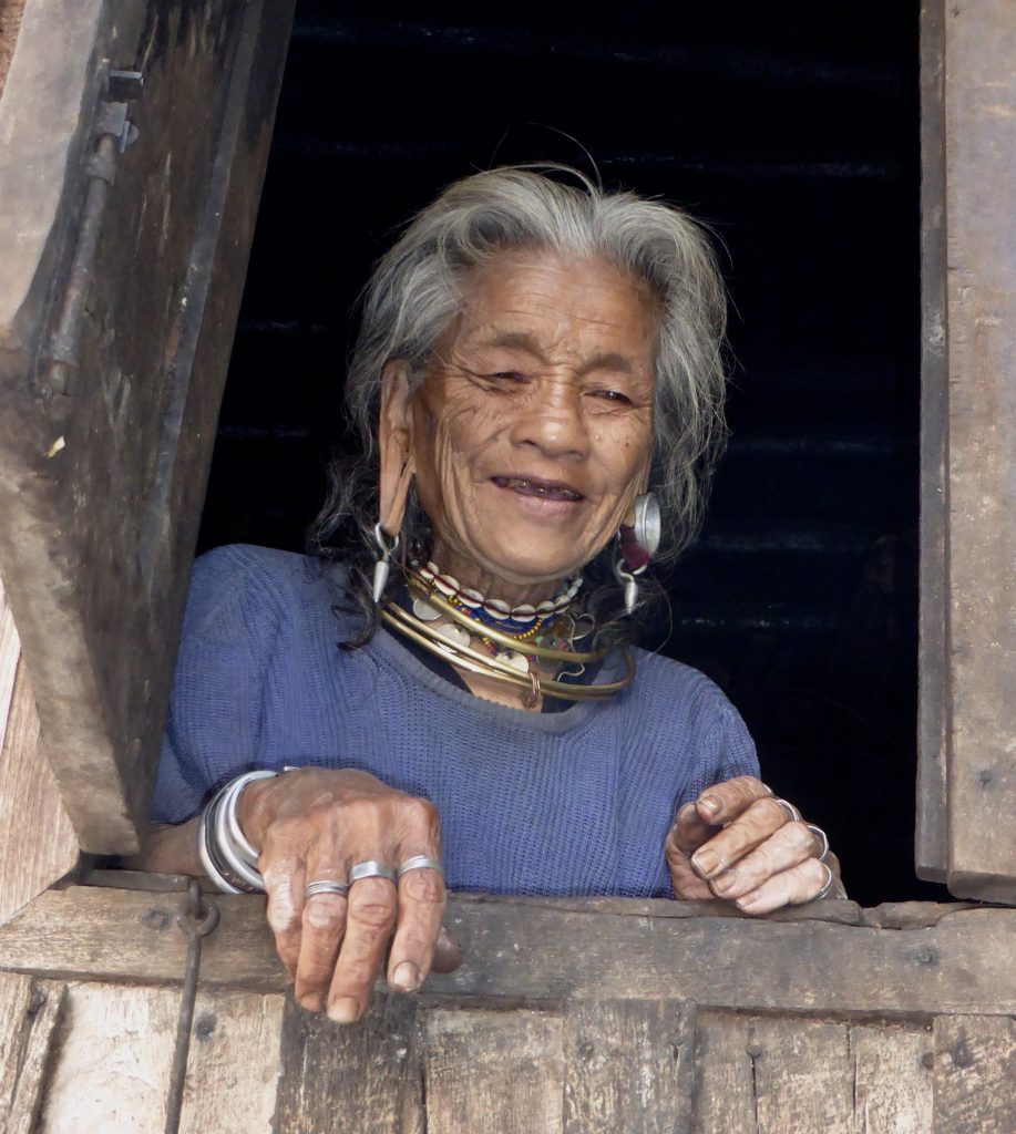Kayaw woman peers from her window in Htay Kho Village